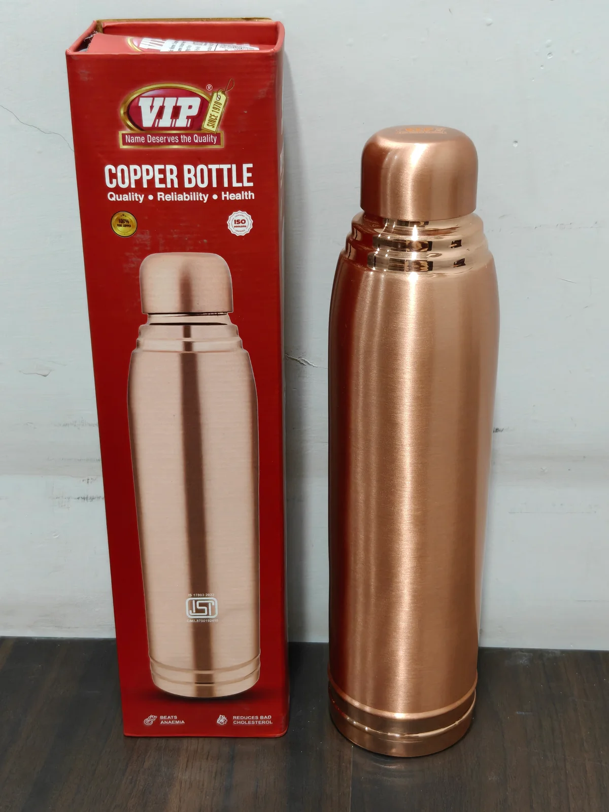 Detail view of the open copper water bottle and threaded cap