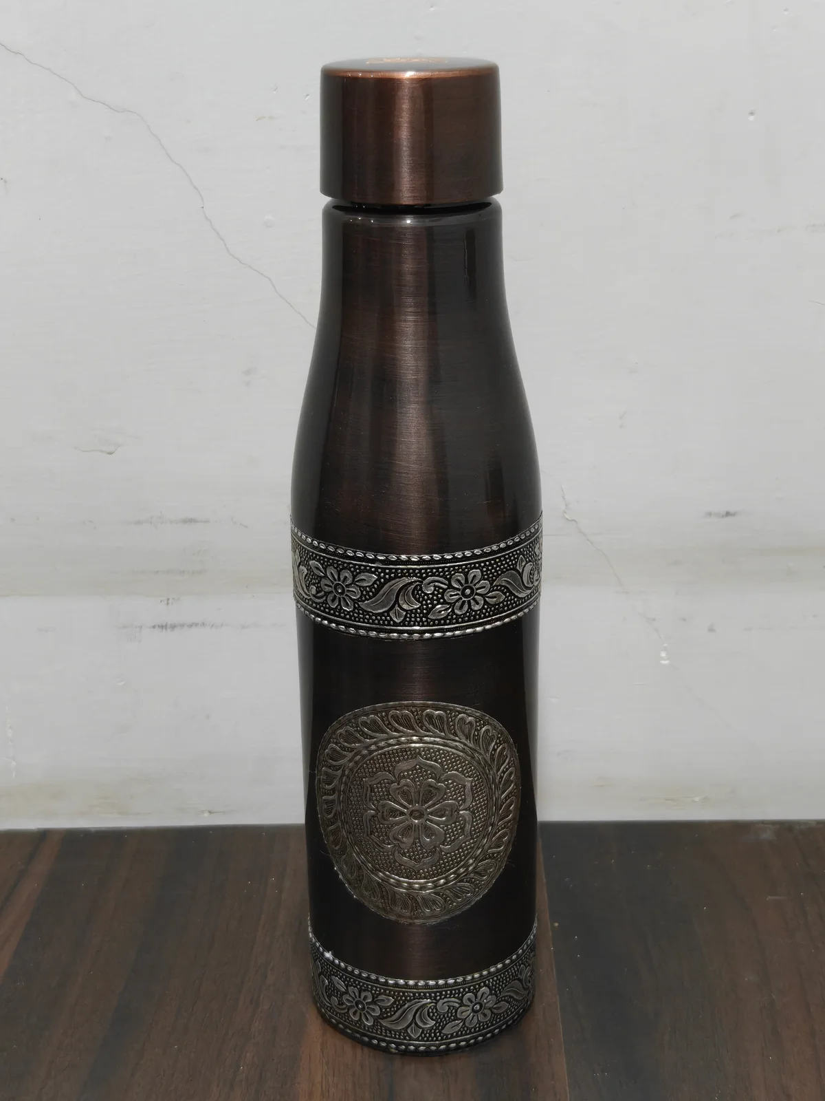 VIP Solo antique silver copper bottle on a luxury dining table